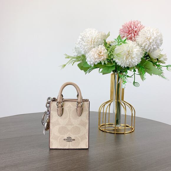 Coach CX069 North/South Mini Tote Bag Charm In Signature Canvas IN Sand Taupe - Picture 1 of 6